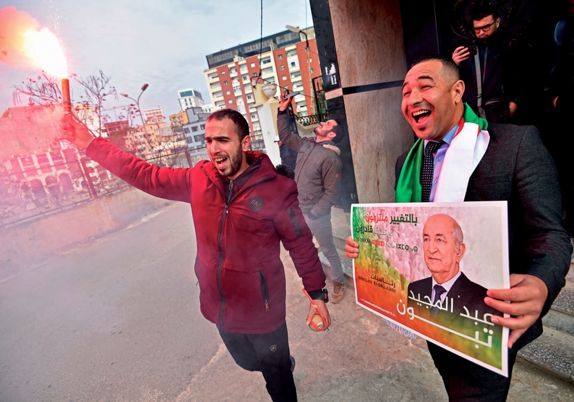 Supporters of Algerian President Abdelmadjid Tebboune celebrate his victory in the presidential elections on December 13, 2019. 