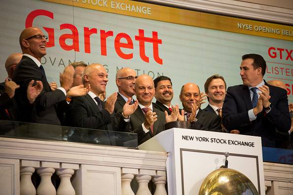 Olivier Rabiller, president and chief executive officer of Garrett Motion Inc., center, rings a the opening bell celebrating the company's spin off from Honeywell International Inc. on the floor of the New York Stock Exchange (NYSE) in New York, U.S., on Monday, Oct. 1, 2018. U.S. stocks rose toward records, while the Canadian dollar and Mexican peso gained after negotiators agreed to a new version of the Nafta trade pact. (Getty)