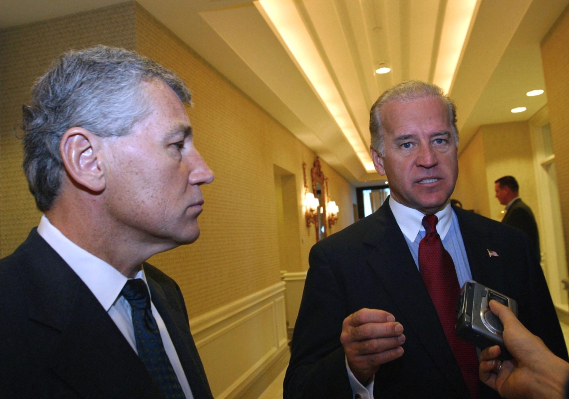 US Senator Joseph Biden (R), D-Delaware, speaks to the press in Doha 8 December 2002 as Senator Chuck Hagel, R-Nebraska, looks on after the two senators visited the As-Saliyah base.