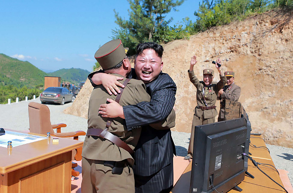 This picture taken on July 4, 2017 and released by North Korea's official Korean Central News Agency (KCNA) on July 5, 2017 shows North Korean leader Kim Jong-Un (C) celebrating the successful test-fire of the intercontinental ballistic missile Hwasong-14 at an undisclosed location. (Getty)