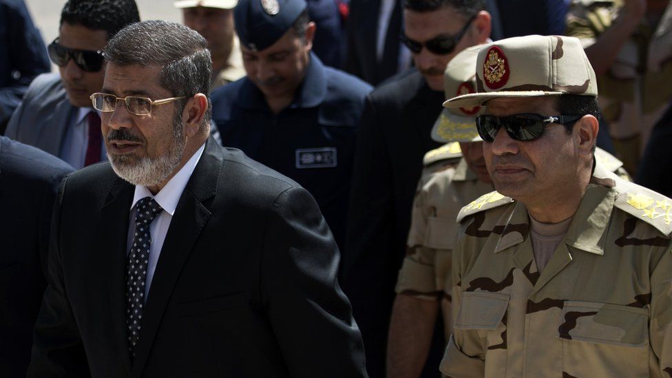 "President Mohammed Morsi (L) named the then Gen Sisi as his defense minister. (AFP)"
